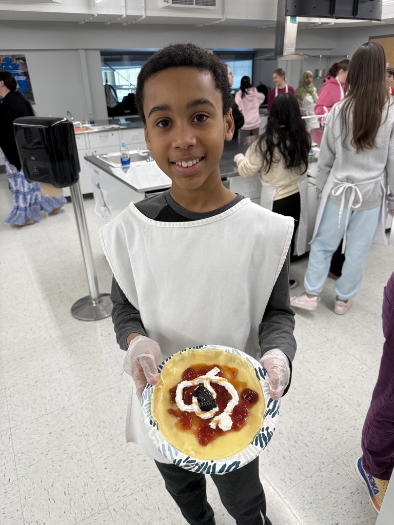 Crepe day at shaker middle school with a student holding a crepe