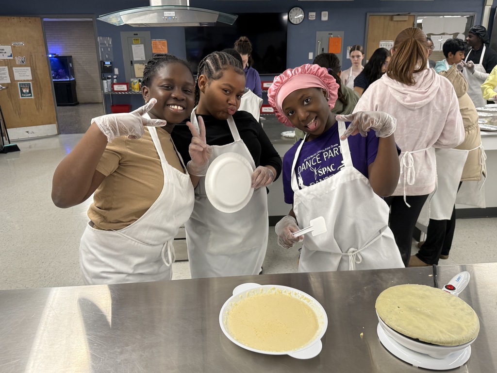 Crepe day at shaker middle school with three students posing as they make crepes
