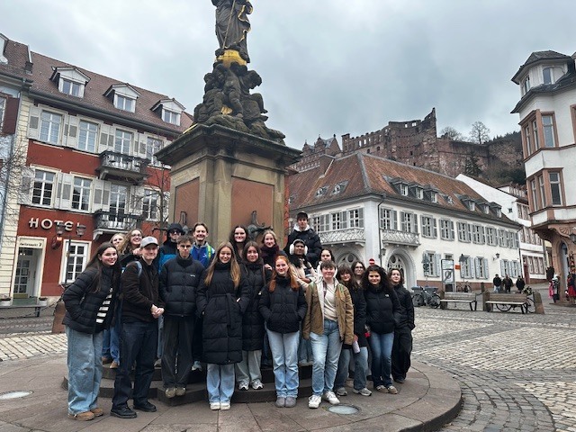 students standing outside in front of statue for german exchange program