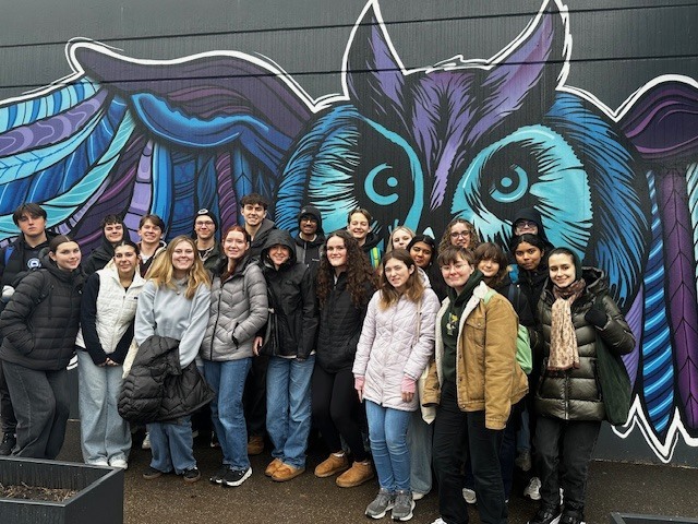 students standing in front of image of bird for german exchange program
