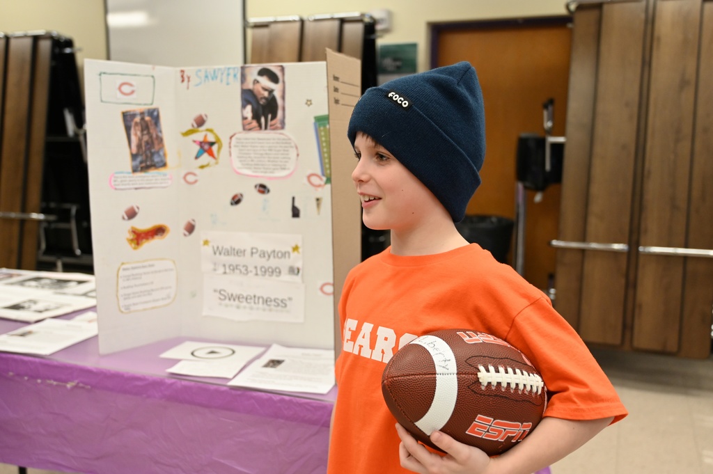 A student presents his project on Walter Payton.