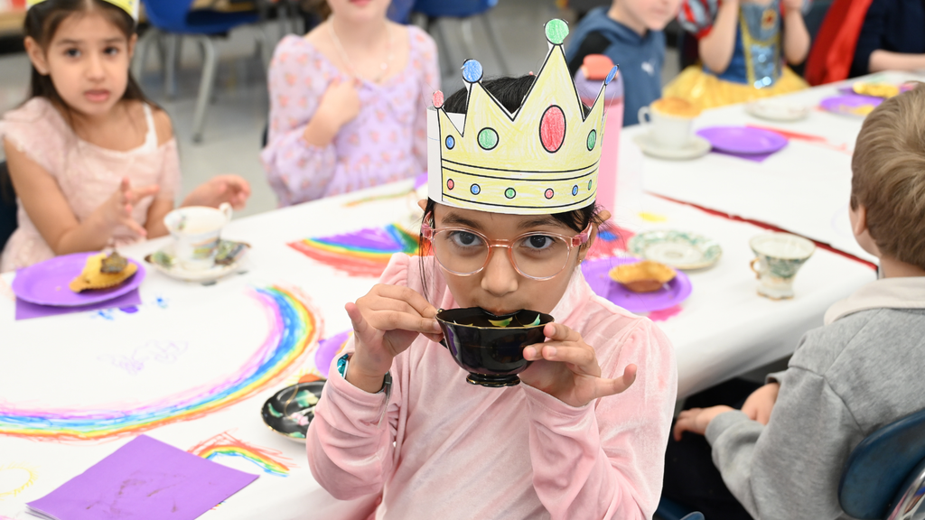 Southgate Kindergartener sipping tea at Kings & Queens Day