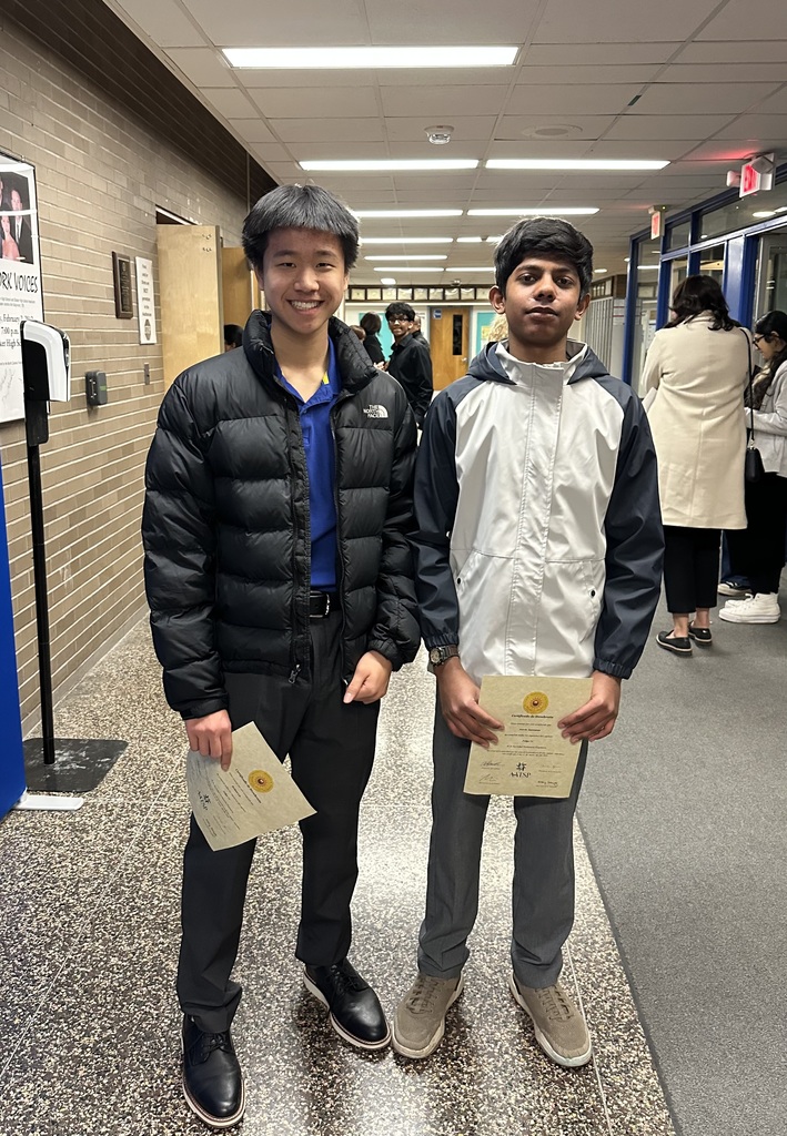 Two students smiling for photo at spanish honors society