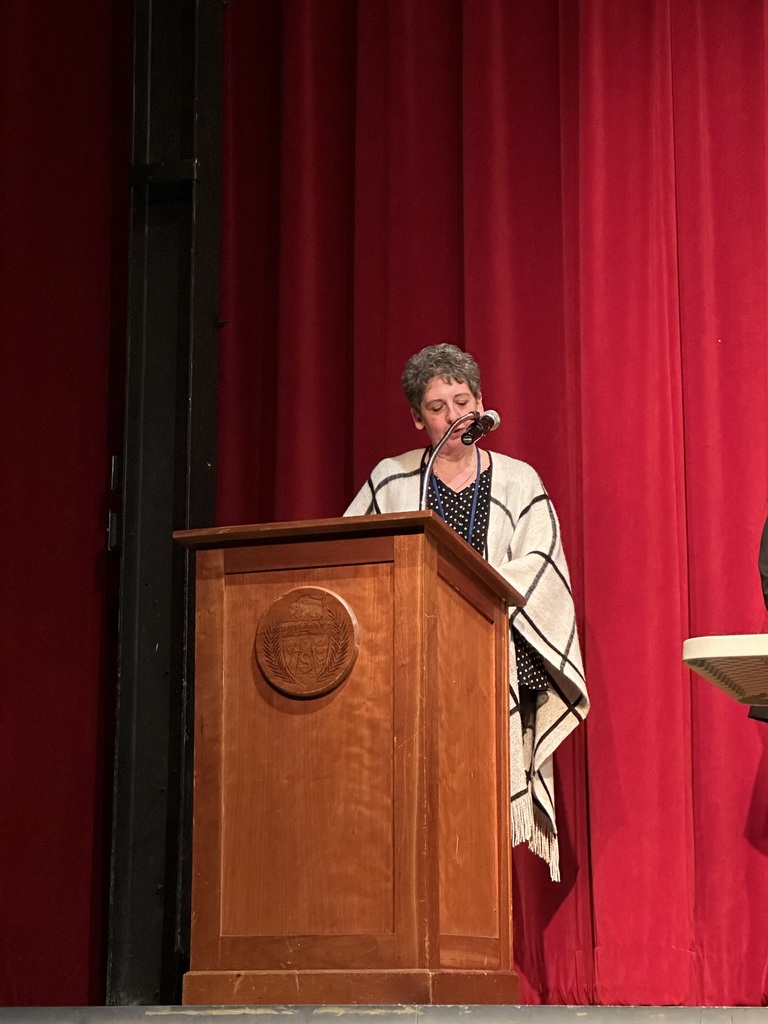 Women speaking at Spanish honors society