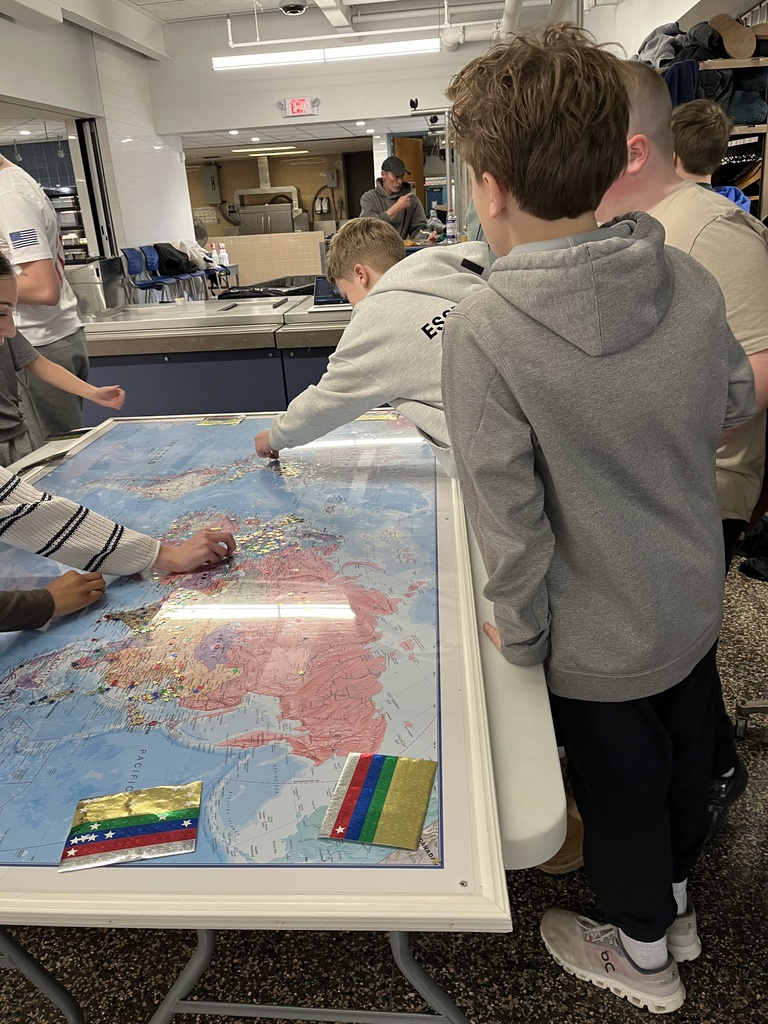 Students placing stars on the globe map