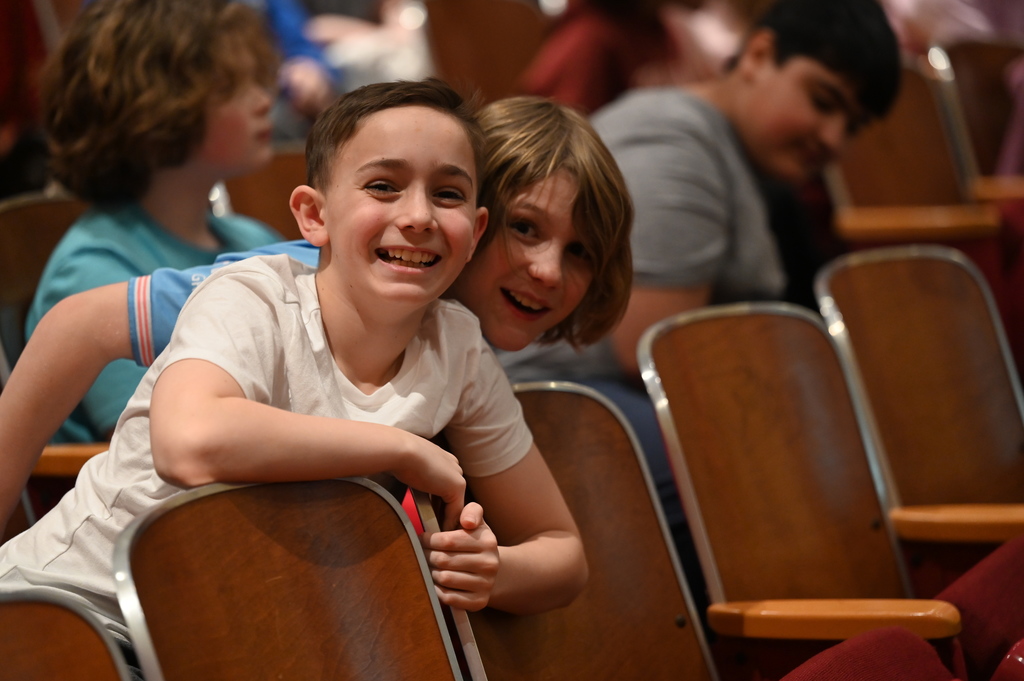 two kids happy to be sitting in the stands