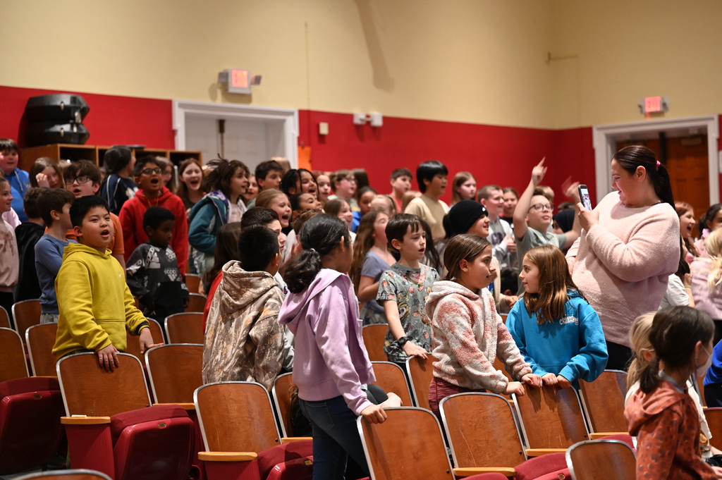 students singing along to the band