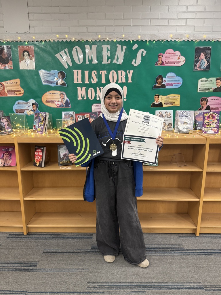 Inaayah holding up her awards