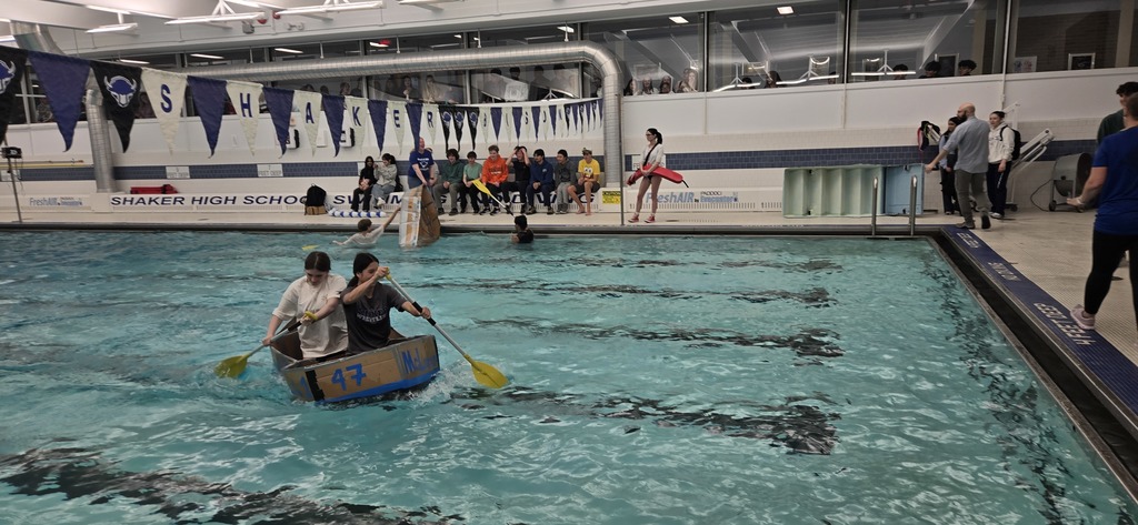 SHS students row across the pool in their boat