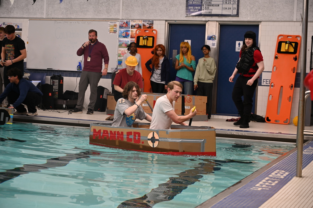 SHS students row across the pool in their boat "The Payload"