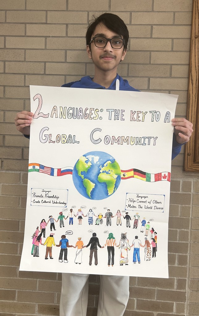 Student holding a poster for a poster contest