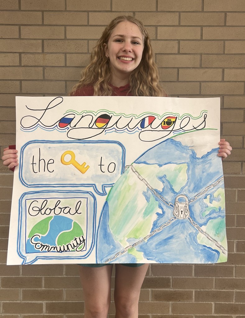 Student holding a poster for a poster contest