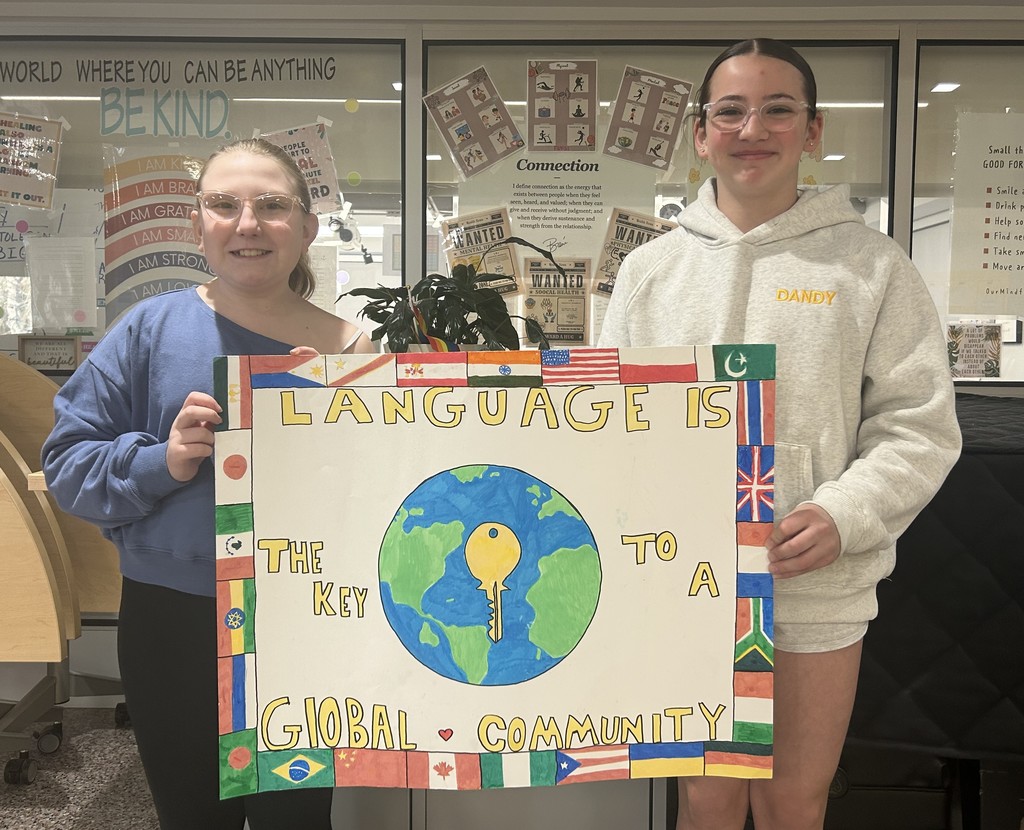 Students holding a poster for a poster contest