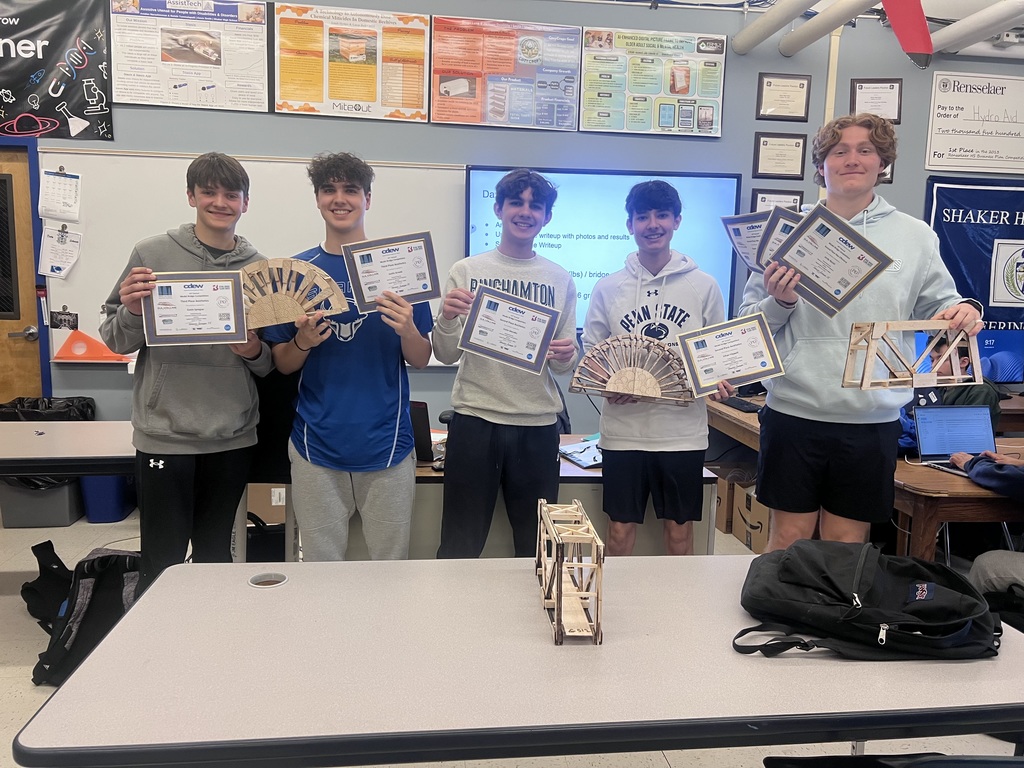 Students holding awards after building some cool bridges
