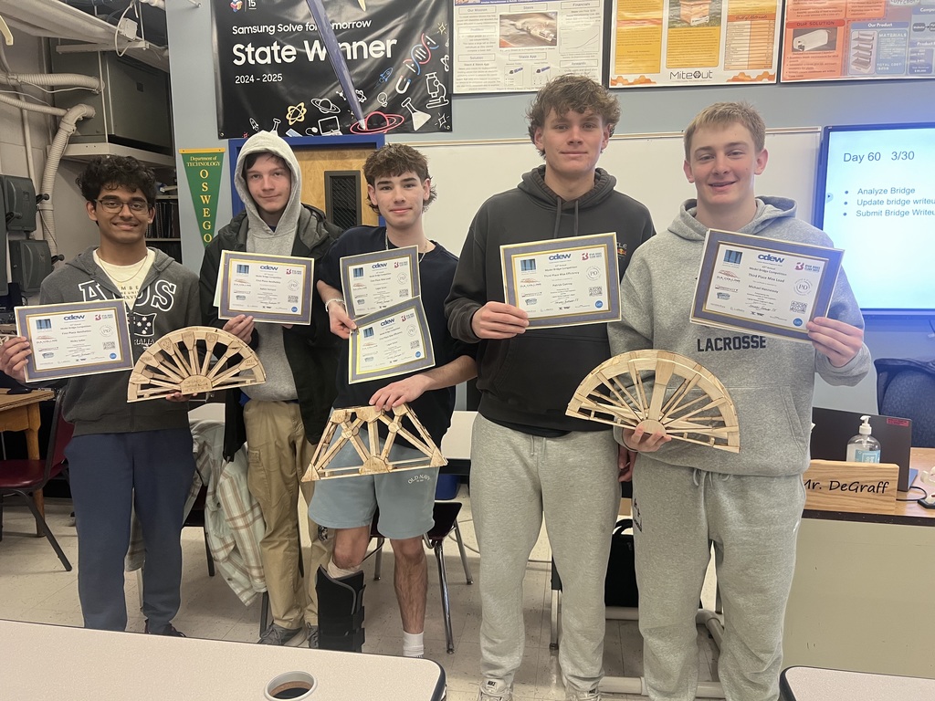 Students holding awards after building some cool bridges