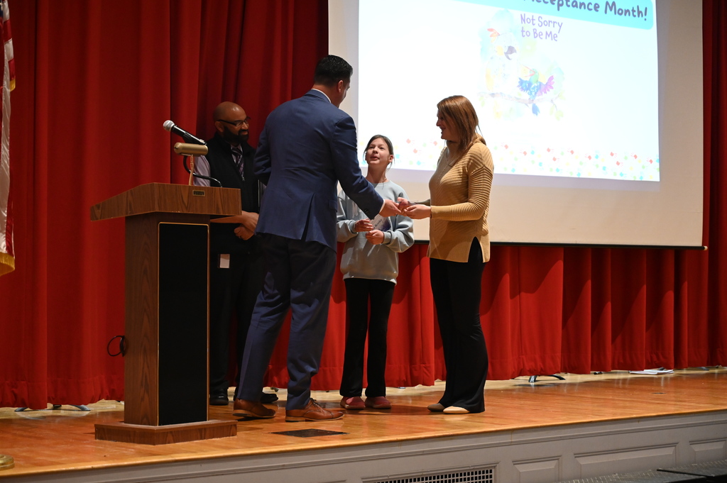 Senator Ashby giving medal to Isla and Vicky