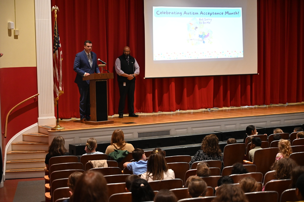 Senator Ashby giving medal to Isla and Vicky