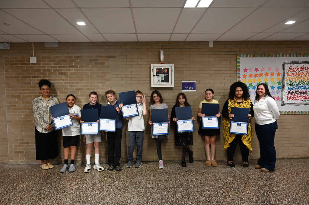Eight students pose with their certificates of recognition, along with the two teachers who nominated them for the award.