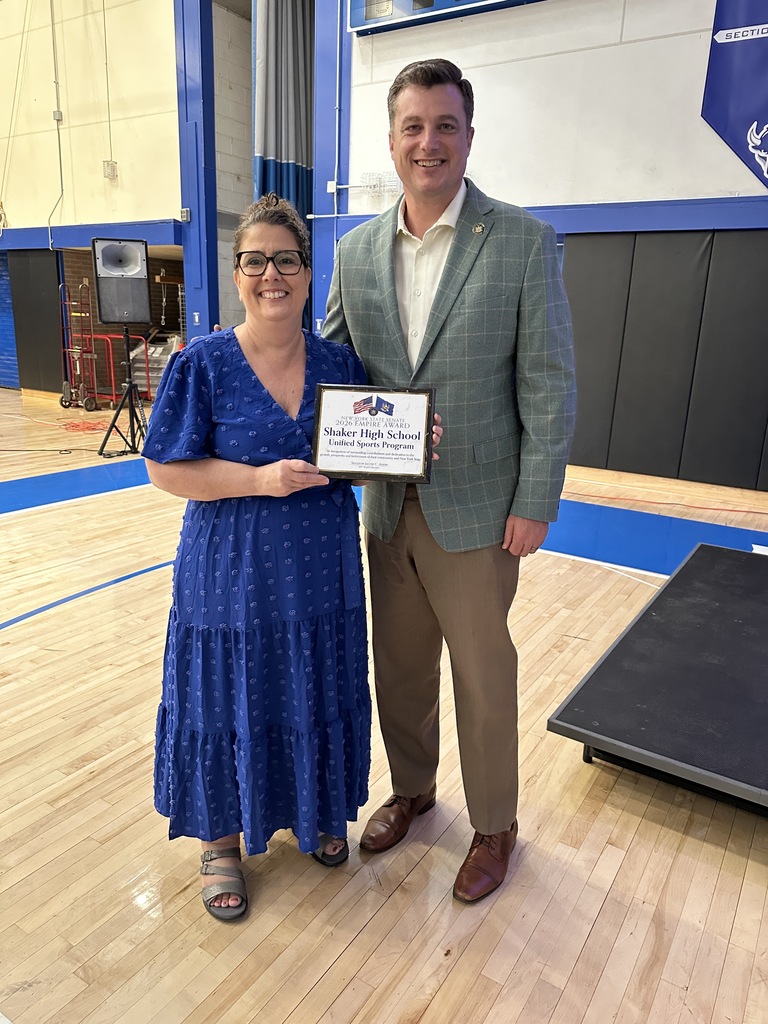 Superintendent Kathleen Skeals holds a recognition while posing with Senator Jake Ashby.