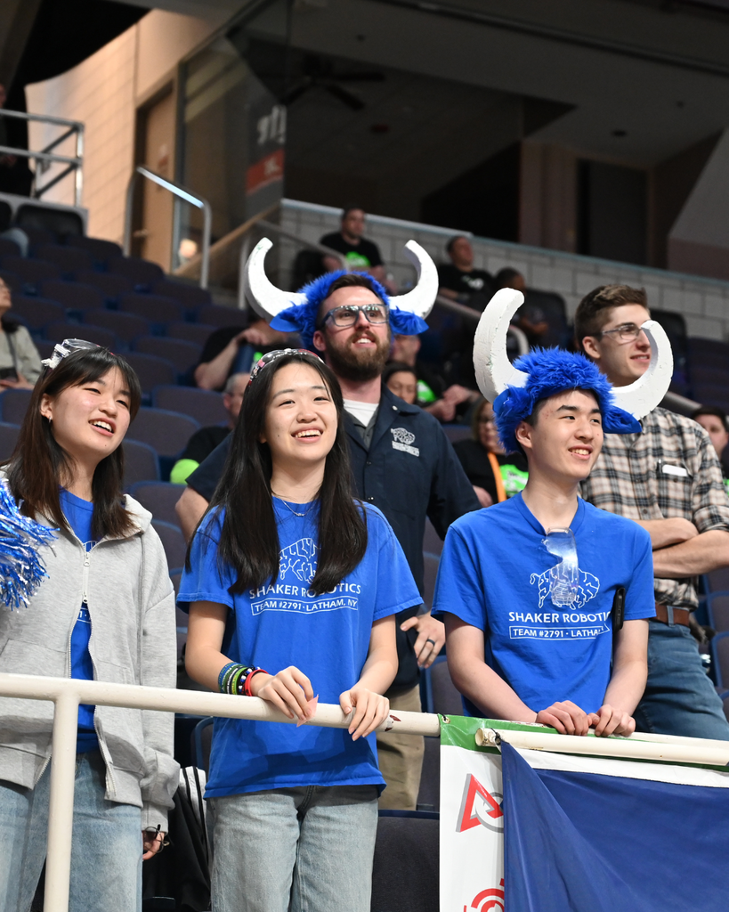 Robotics members and teachers/advisors watching a match