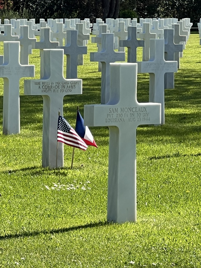 A cemetery in Normandy with headstones in rows.