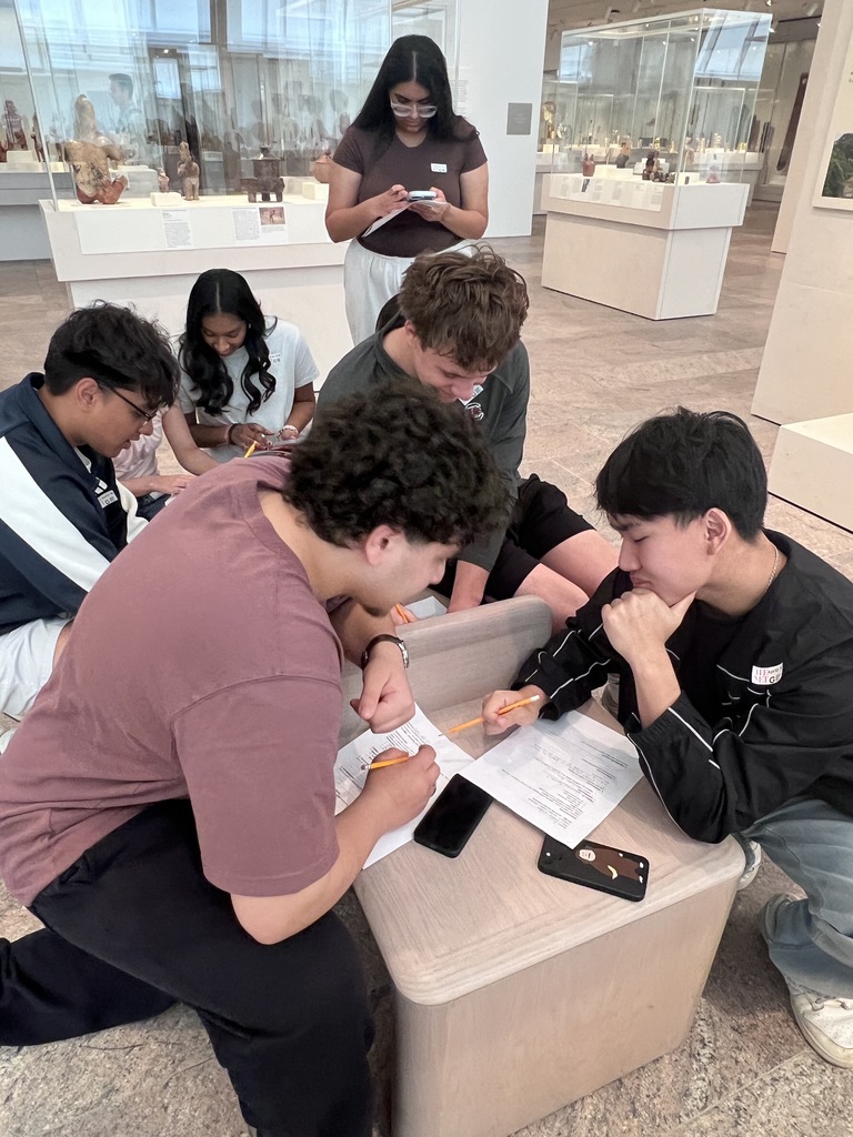 A group of students take notes inside the museum.
