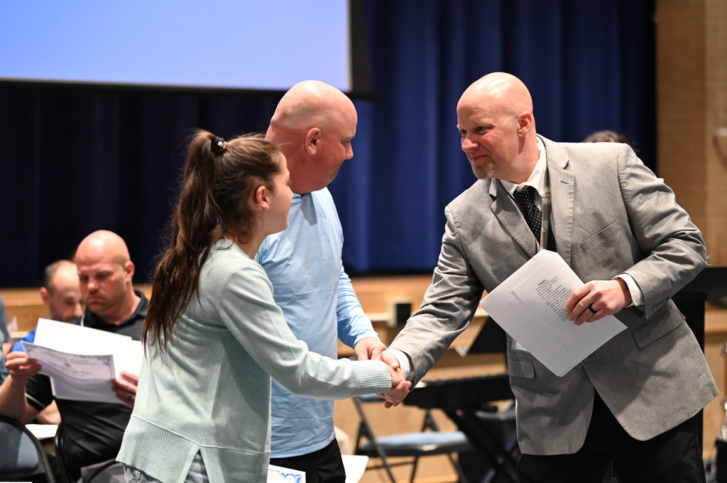 Dave Stadtlander, Supervisor of Secondary Health, P.E., and Athletics, shakes Boght Hills recipients' hand