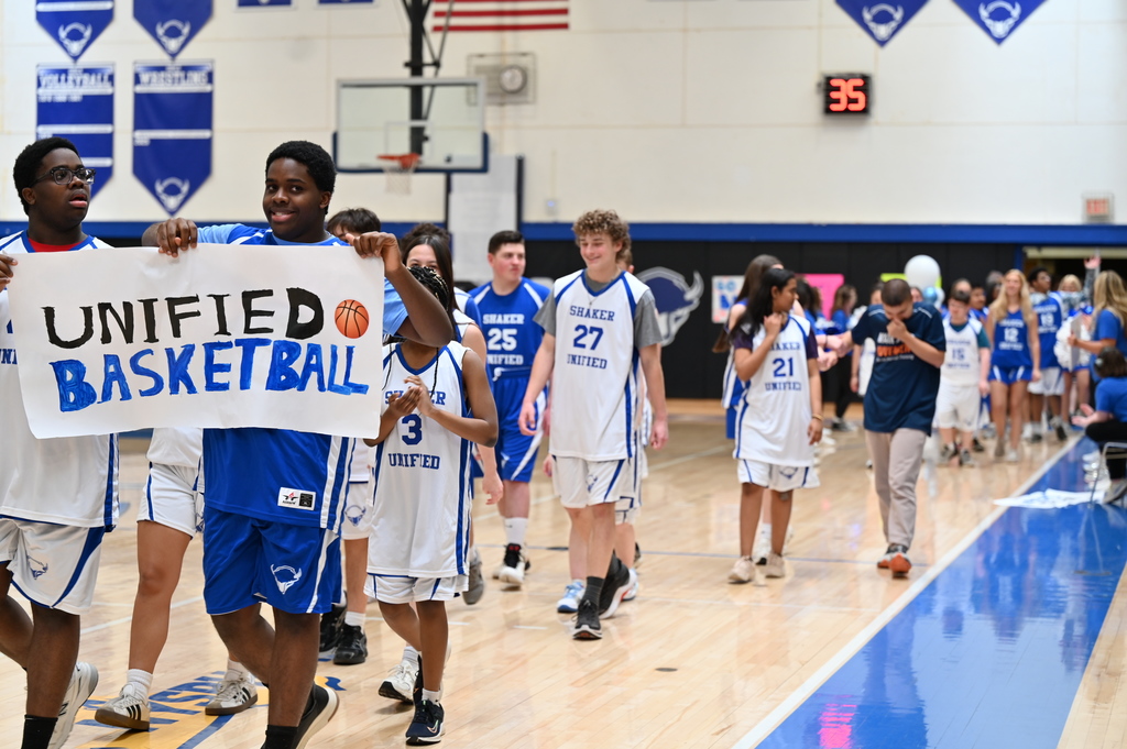 Unified basketball players walk into the gym