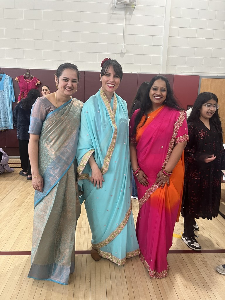 teacher and two others dressed in pretty clothes