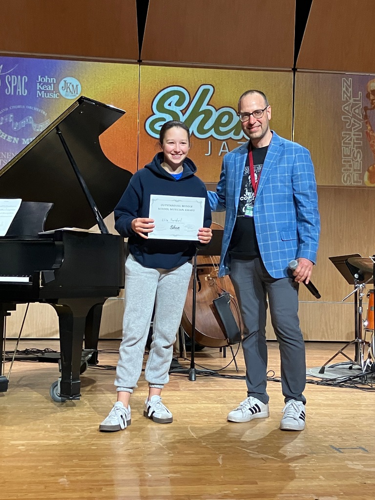 SMS seventh grader Elise Sanderl poses with festival coordinator Brian Carucci after winning "Outstanding MS Musician."
