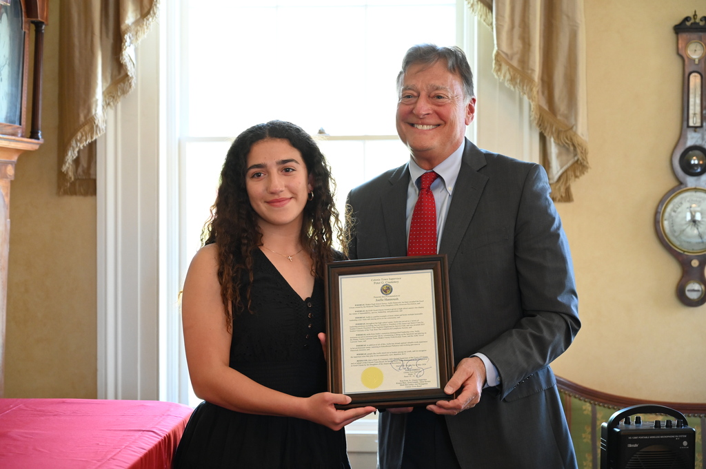 Joelle Hannoush poses with a recognition from Colonie Town Supervisor Peter Crummey.