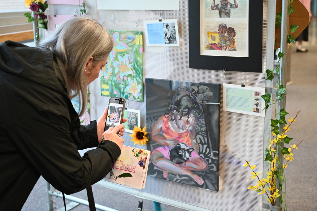 parent taking photo of artwork