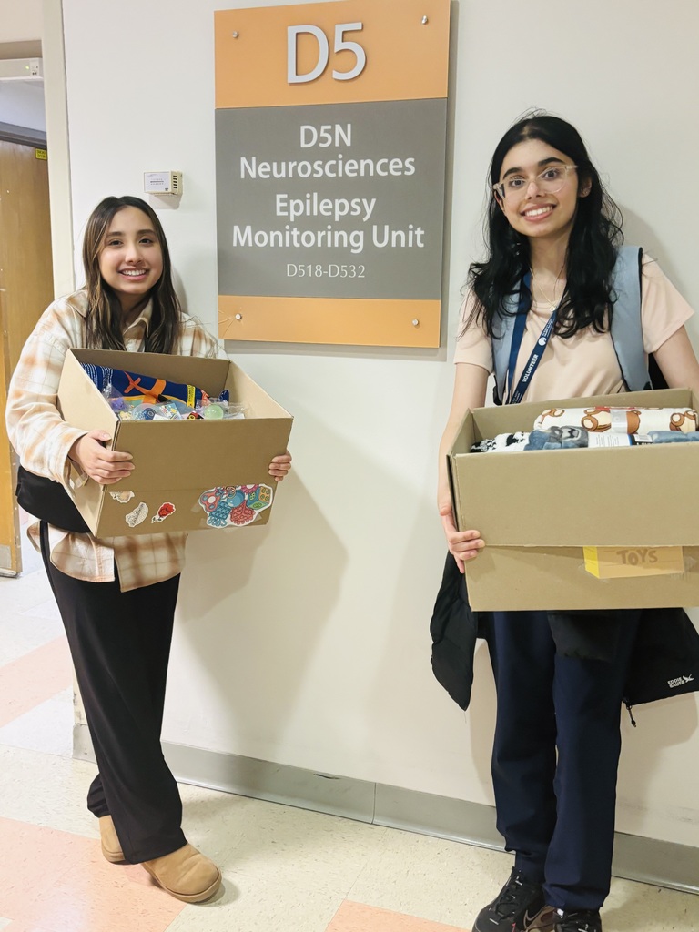Giving back to the community, students holding fidget toys they collected for donations