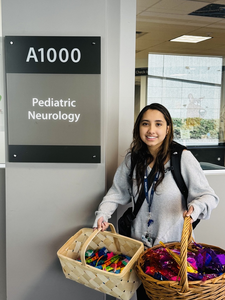 Giving back to the community, student holding fidget toys they collected for donations