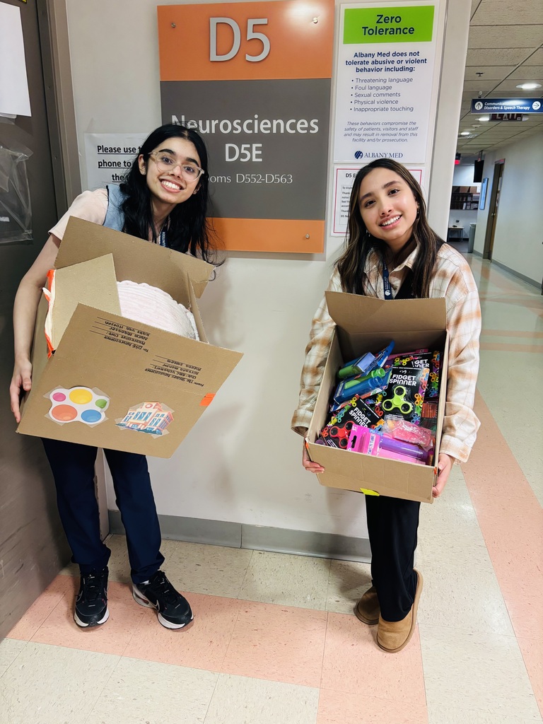 Giving back to the community, students holding fidget toys they collected for donations