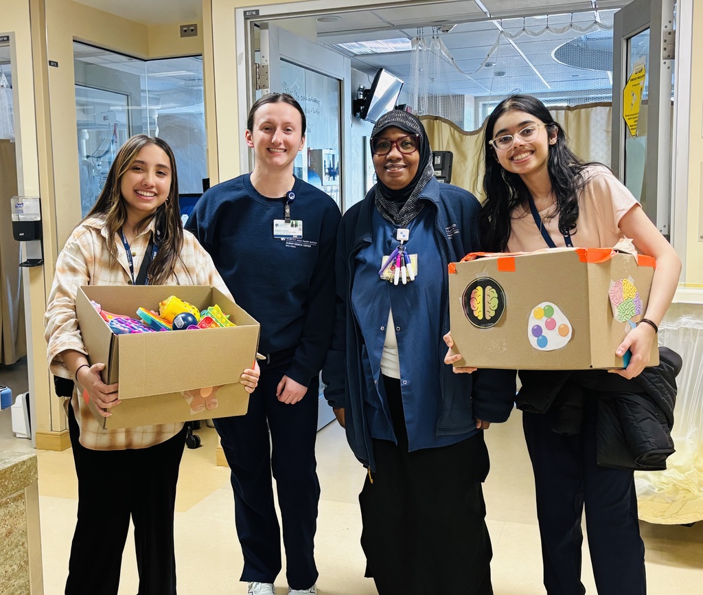Giving back to the community, students holding fidget toys they collected for donations