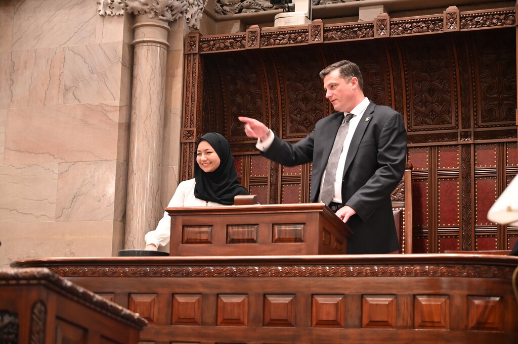 Senator Jake Ashby points out parts of the Senate Chamber to Sima at the dais.