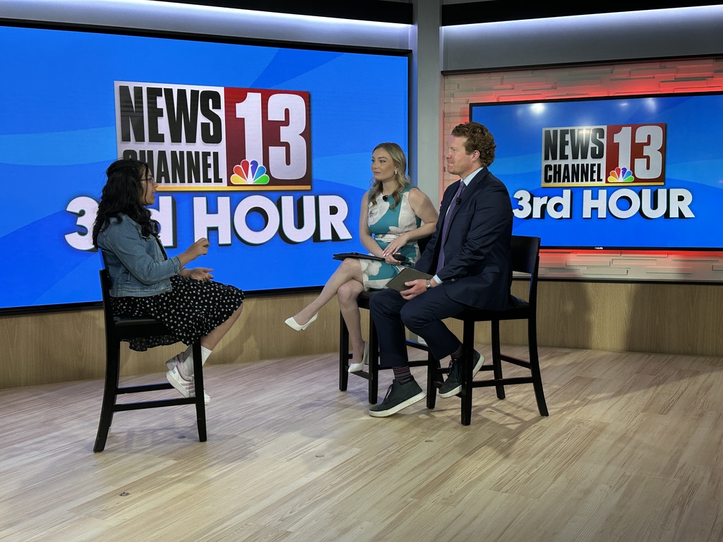 SMS sixth grader Krrisha Agrawal sits across from WNYT morning anchors in an on set interview.