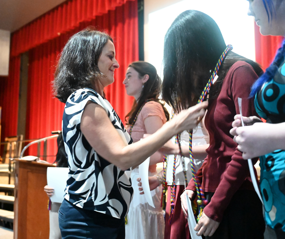 District Art Supervisor Anne Manzella honoring Art Honor Society senior officers