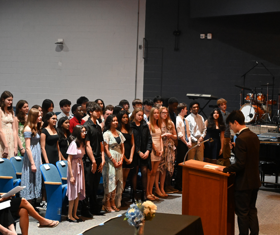 Over 40 students reciting the Tri-M Music Honor Society pledge and getting inducted