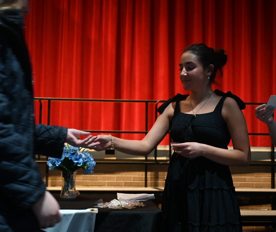 Tri-M Music Honor Society Inductee shaking officer's hand