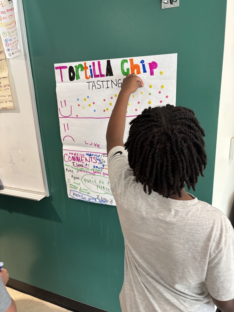 A student puts a star sticker in the smile face section of the taste test reviews.