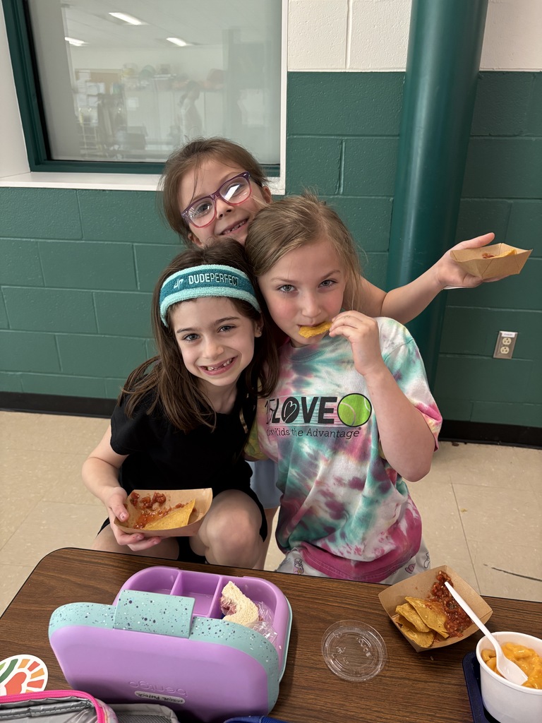 Three students celebrate how much they enjoy the tortilla chip tasting.