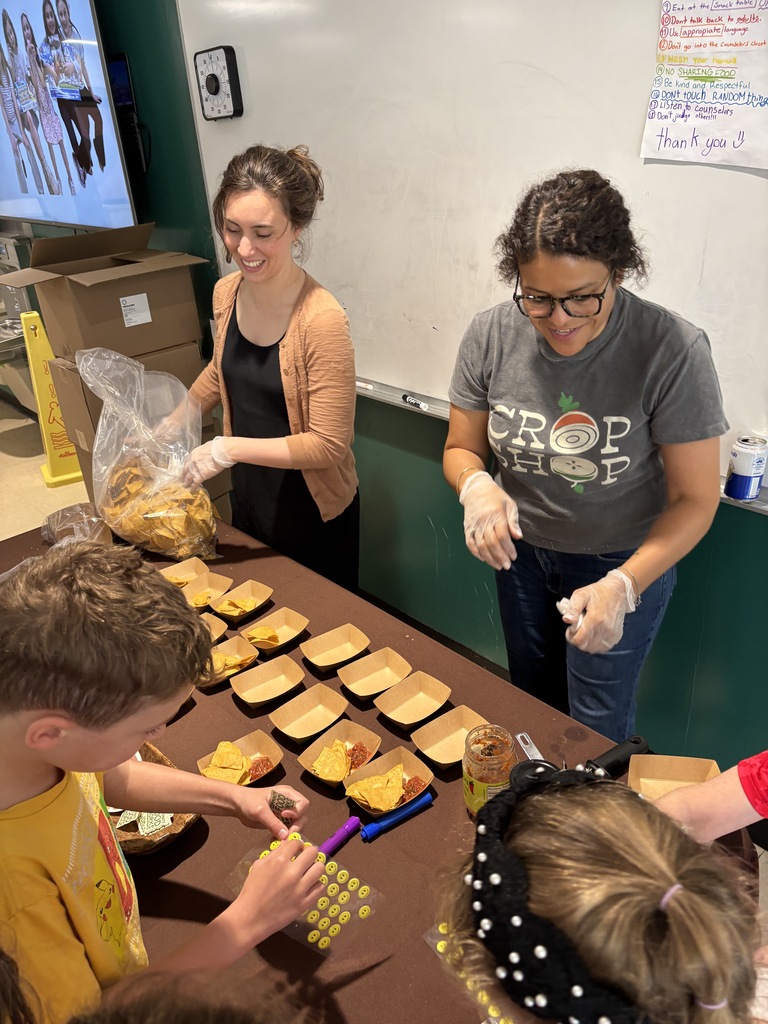 Community Food Works members enjoy handing out samples of tortilla chips.