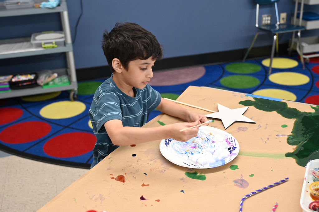student looking at star garden stake