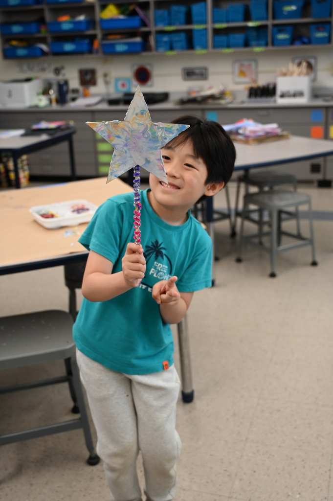 student looking at star garden stake
