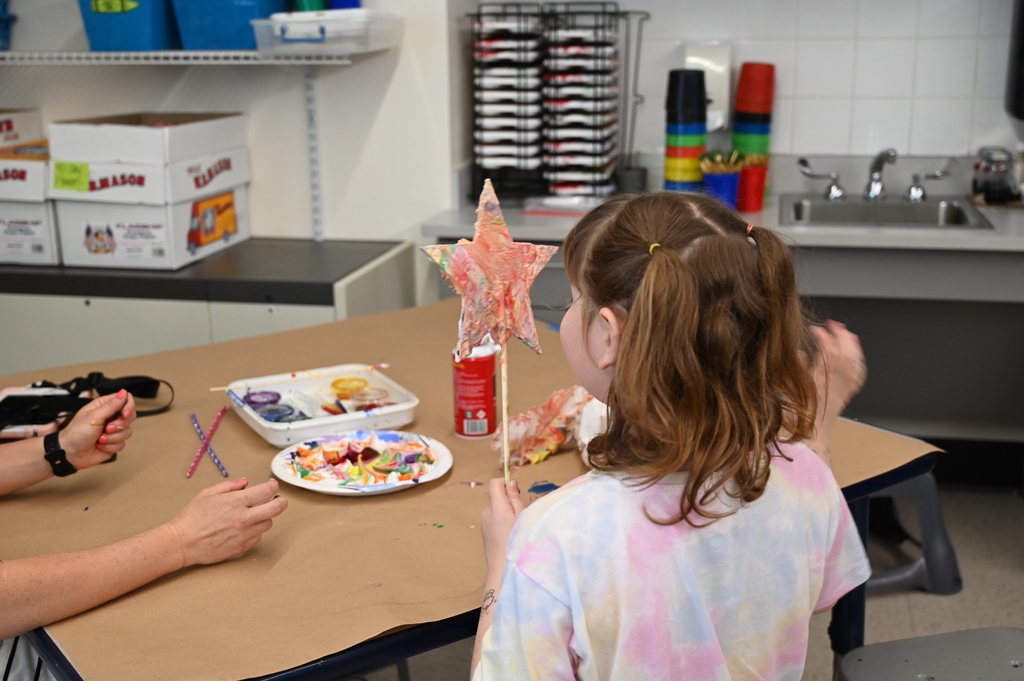 student looking at star garden stake