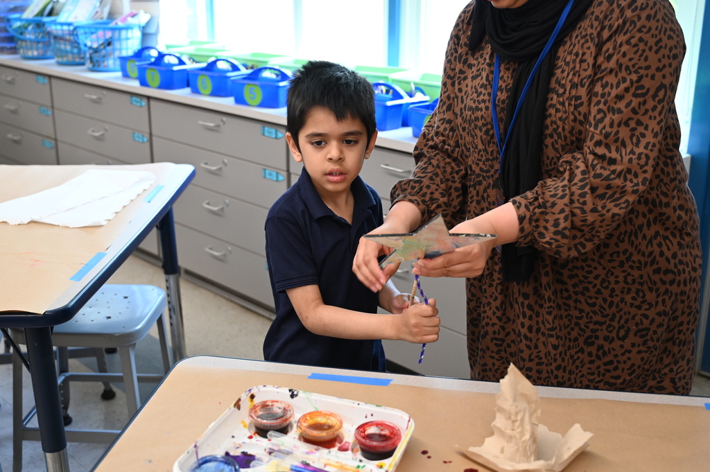 student looking at star garden stake