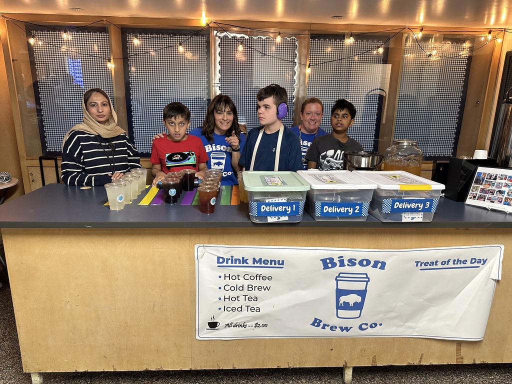 Members of the Bison Brew team stand behind a counter and are ready to serve beverages.