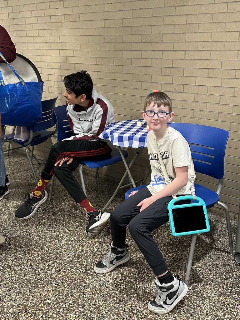 Students sit at a table at the Bison Brew ribbon cutting.
